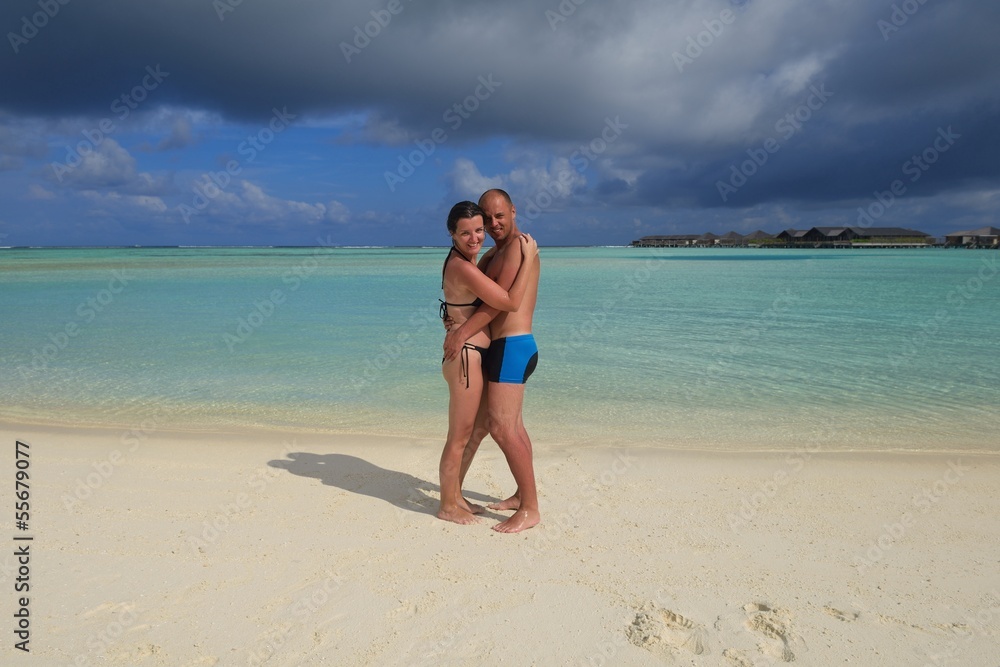 happy young couple have fun on beach