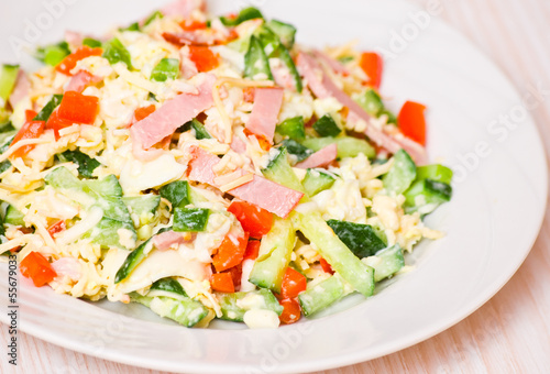 fresh salad with cheese, ham and vegetables