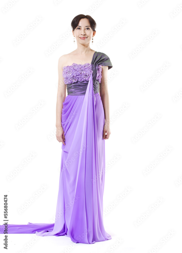 beautiful female fashion model posing in purple dress