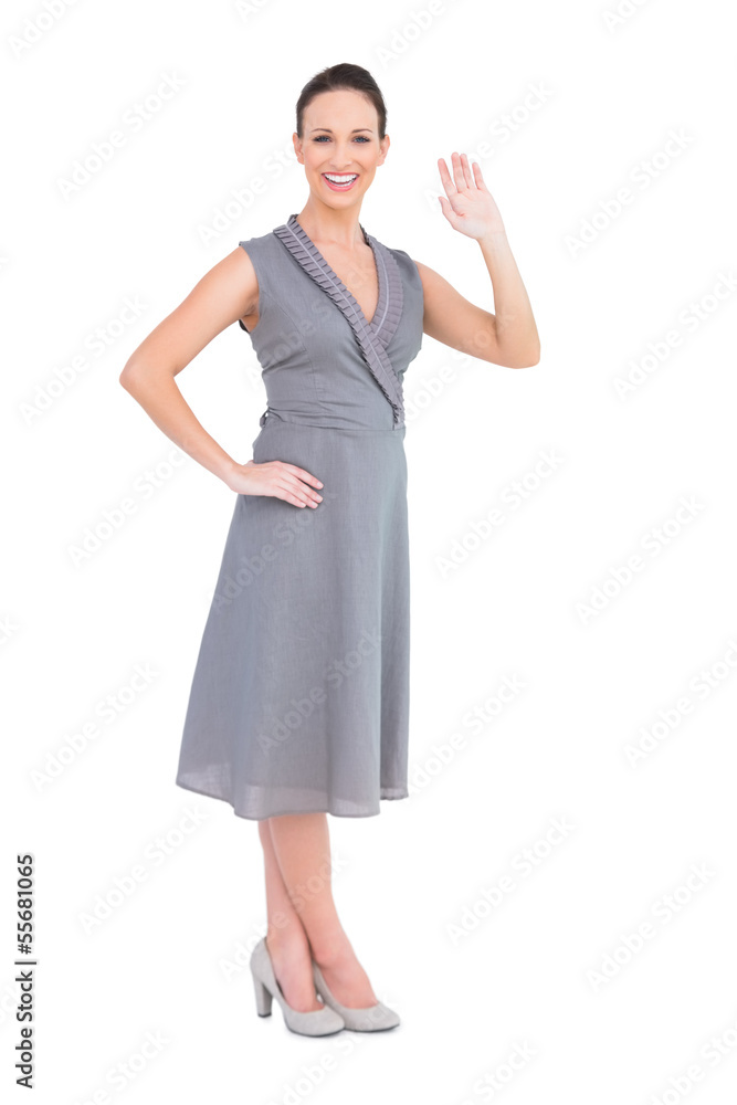 Happy elegant woman in classy dress waving at camera Happy elegant woman in classy dress waving at camera