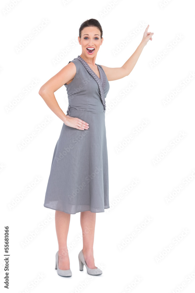 Cheerful gorgeous woman in classy dress indicating direction Cheerful gorgeous woman in classy dress indicating direction