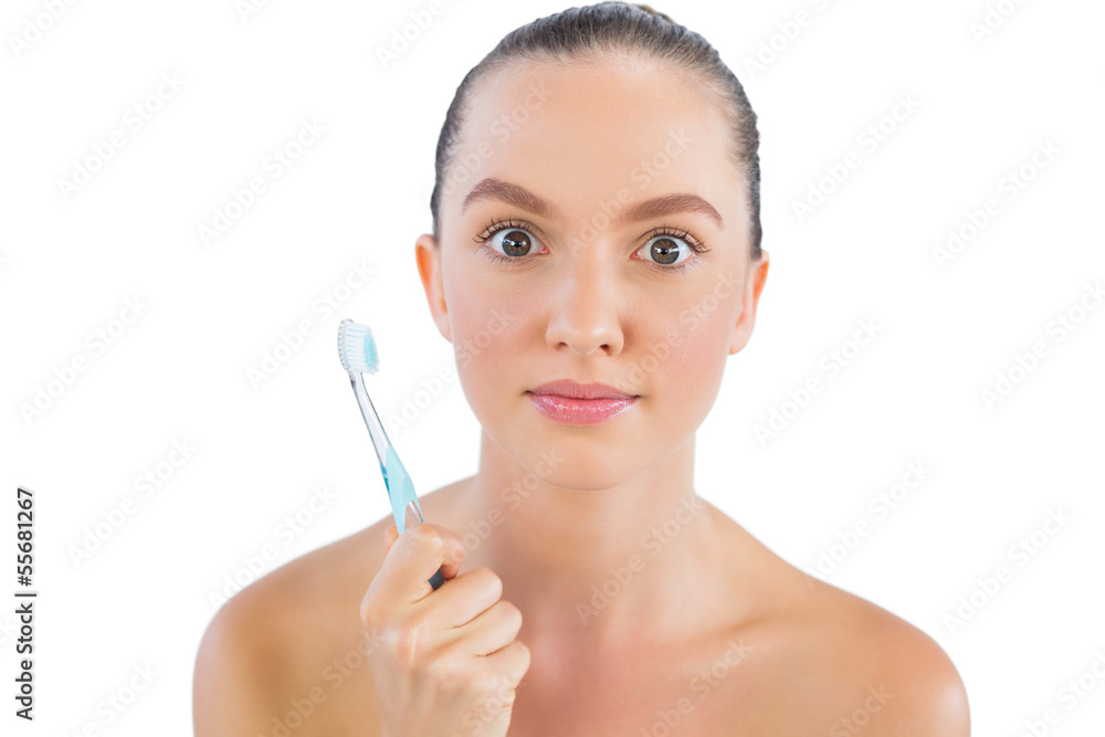 Surprised woman with toothbrush