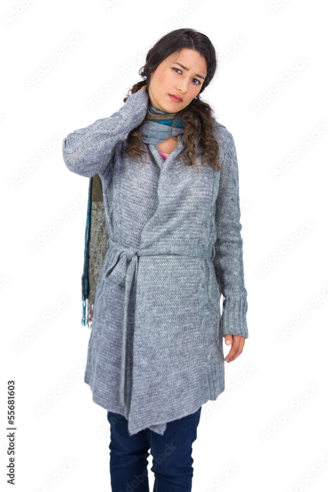 Pretty brunette wearing winter clothes touching her painful neck Pretty brunette wearing winter clothes touching her painful neck