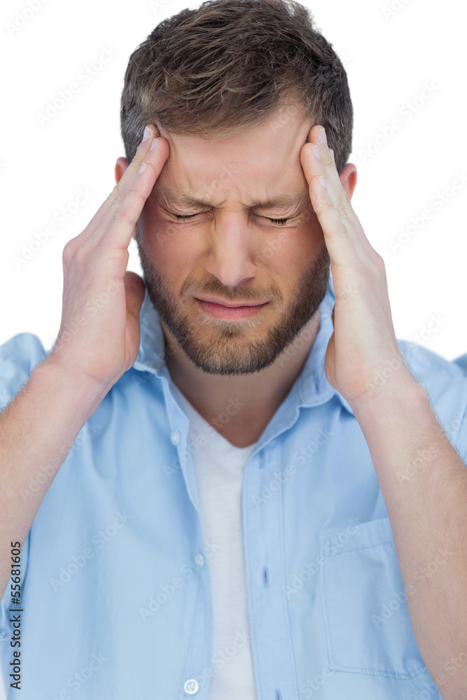 Handsome model having headache and touching his forehead Handsome model having headache and touching his forehead