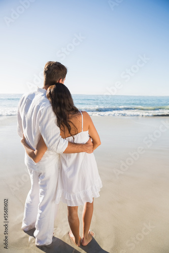 Content couple looking at the waves
