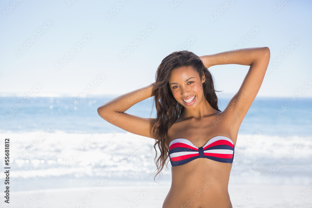 Cheerful sexy tanned brunette posing with hands up Cheerful sexy tanned brunette posing with hands up
