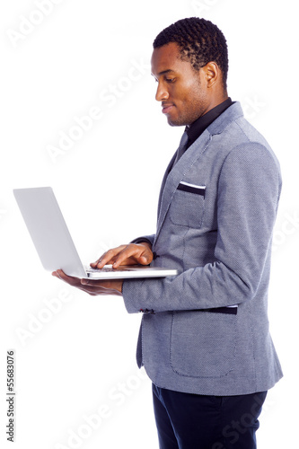 Young business man with a laptop computer isolated over a white