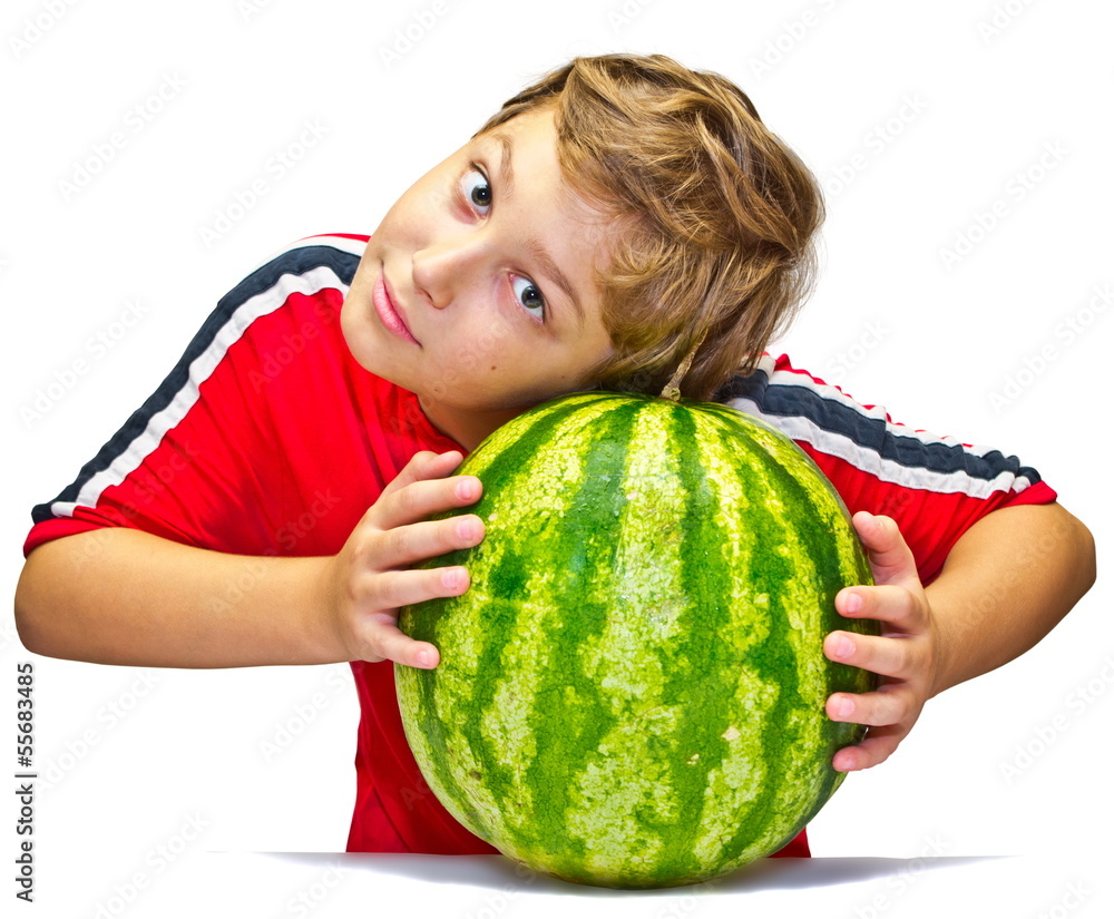 Fototapeta premium Little boy examines the maturity of watermelon
