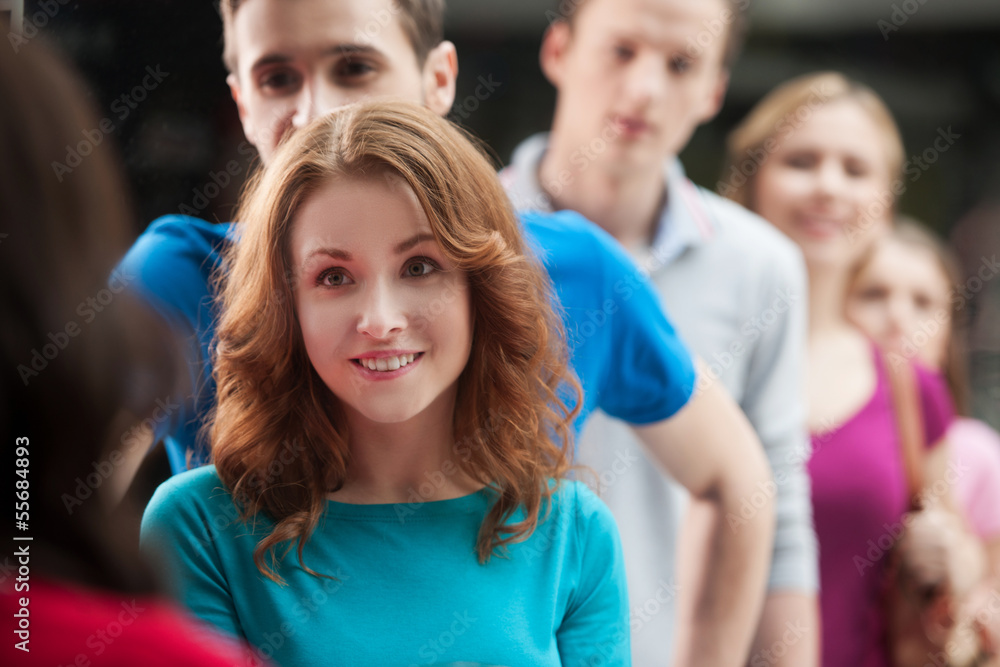 Standing in a row. Young people waiting in line to buy something Standing in a row. Young people waiting in line to buy something