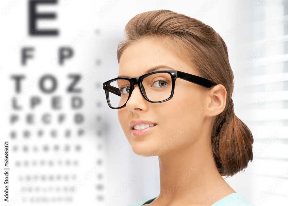 woman in eyeglasses with eye chart woman in eyeglasses with eye chart