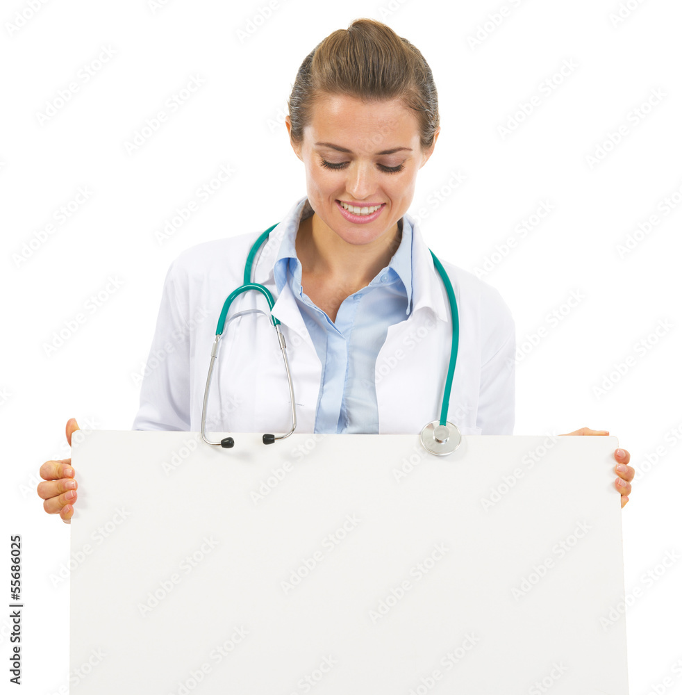 Happy doctor woman looking on blank billboard Happy doctor woman looking on blank billboard