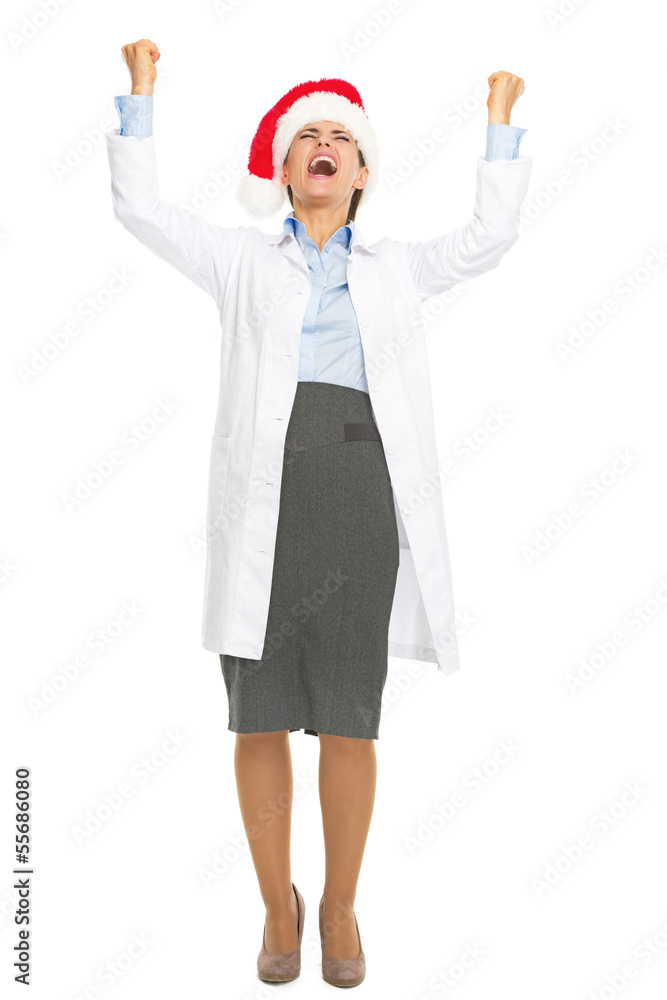 Full length portrait of doctor woman in santa hat rejoicing Full length portrait of doctor woman in santa hat rejoicing
