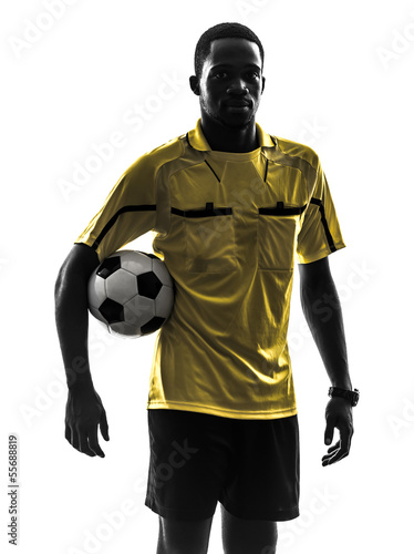 one african man referee standing holding football silhouette