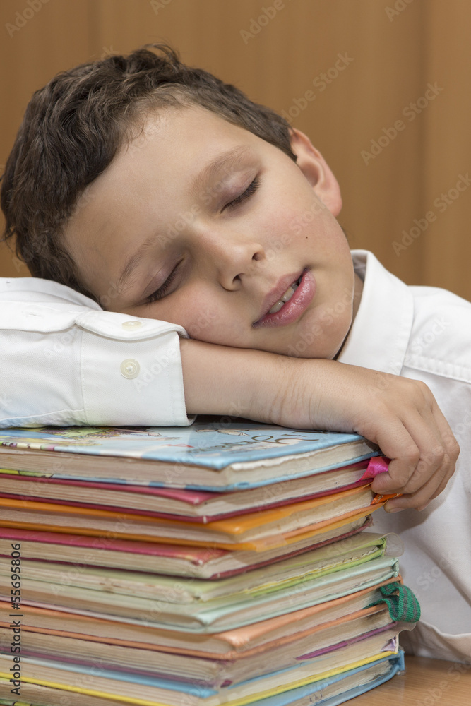 Student is sleeping on stack of books Student is sleeping on stack of books