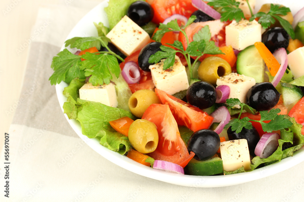 Fresh salad in plate on wooden table Fresh salad in plate on wooden table