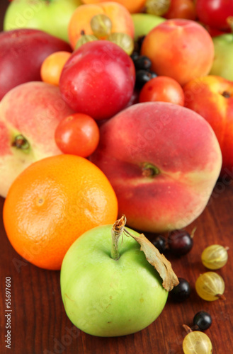 Assortment of juicy fruits  on wooden background