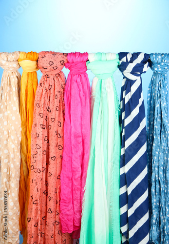 Colored scarves on blue background © Africa Studio