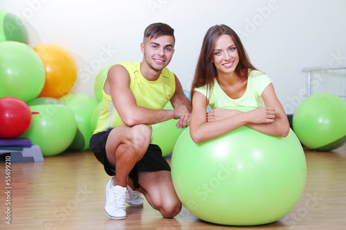 Girl and guy in fitness room
