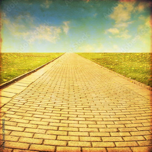 Grunge image of stone pathway in the field.