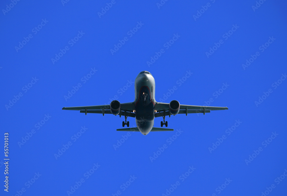 Airliner en face against bright blue sky