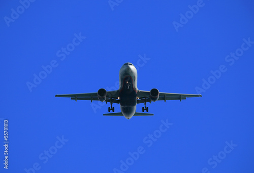 Airliner en face against bright blue sky