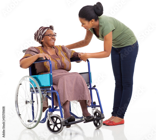 african girl talking to disabled senior mother