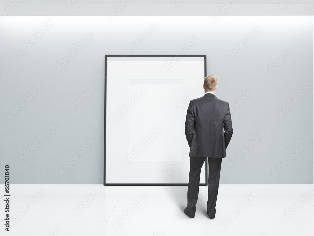 Fototapeta premium businessman looking at blank poster