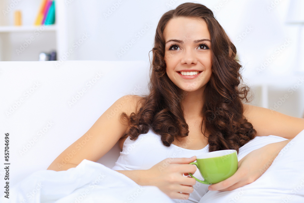 Young woman having cup of tea at home Young woman having cup of tea at home