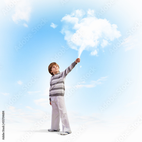 Cute boy catching clouds