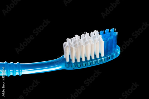 One toothbrush over black background