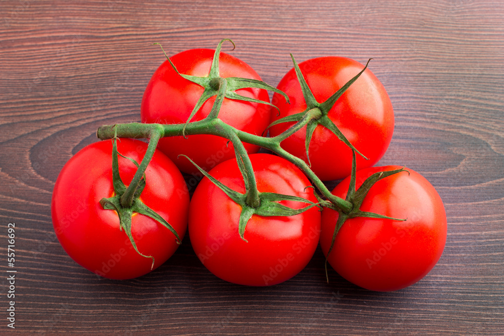 Tomatoes bunch on wooden table Tomatoes bunch on wooden table