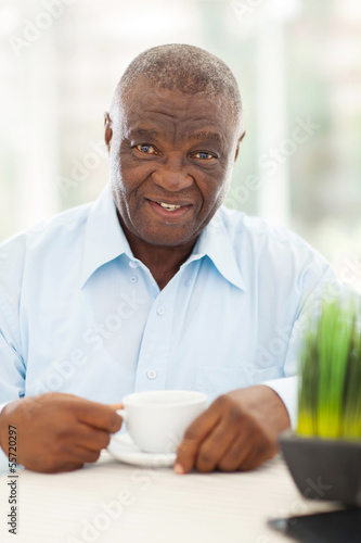 elderly african american man having coffee