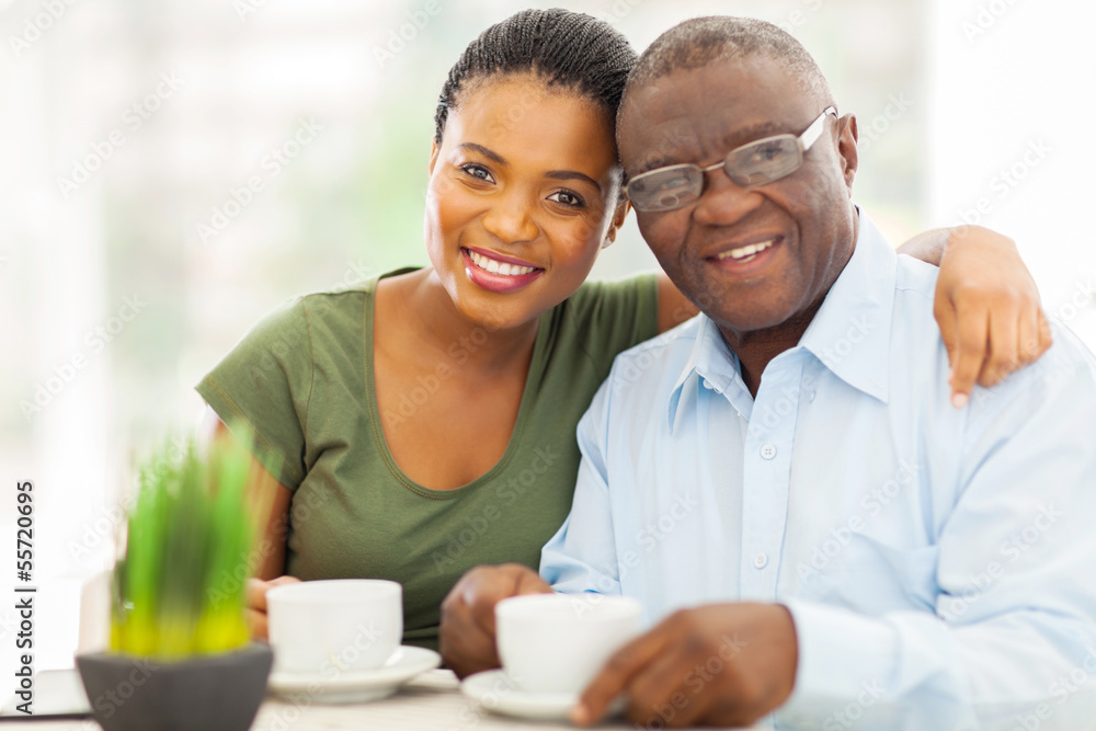 young adult african girl and father having coffee young adult african girl and father having coffee
