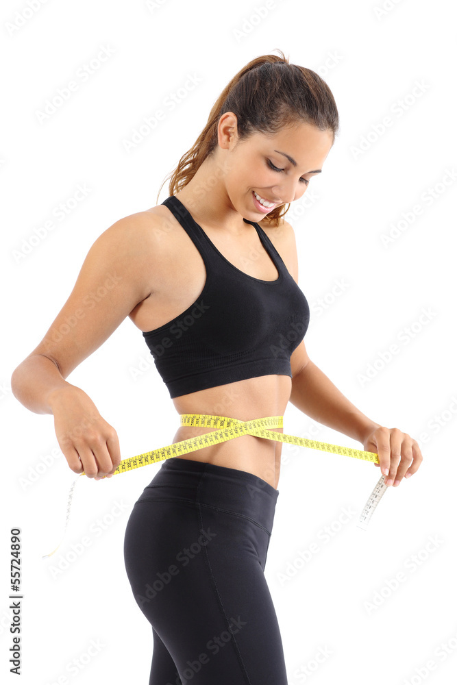 Sportswoman measuring her waist with a measure tape Sportswoman measuring her waist with a measure tape