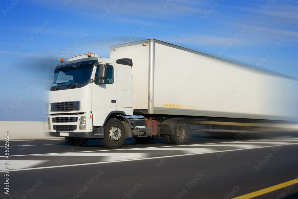 Truck with big white trailer in motion, modified image Truck with big white trailer in motion, modified image
