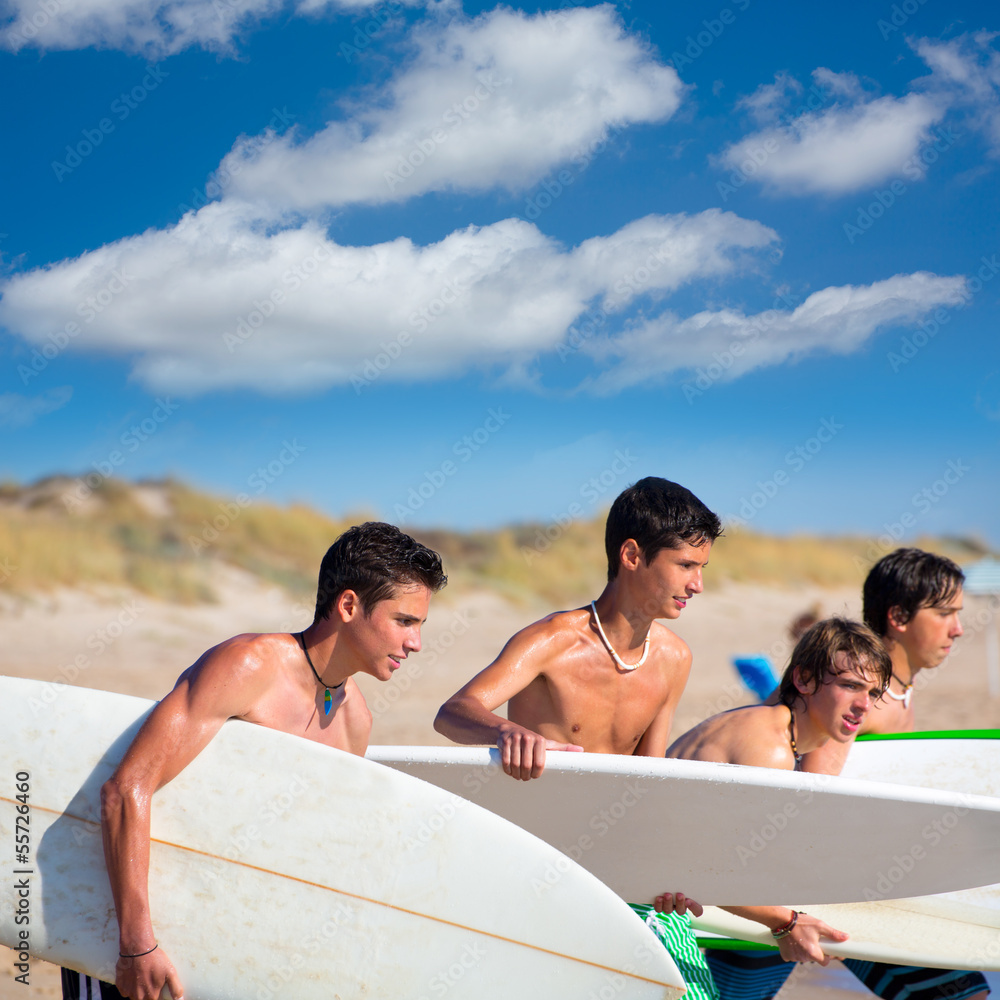 Surfer teen boys talking on beach shore Surfer teen boys talking on beach shore