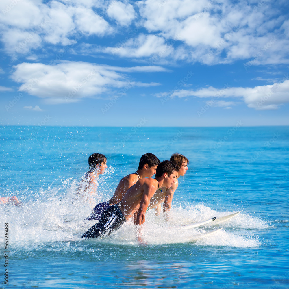 Boys surfers surfing running jumping on surfboards Boys surfers surfing running jumping on surfboards
