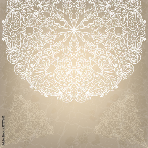 Beautiful wedding card with white lace round ornament on an old