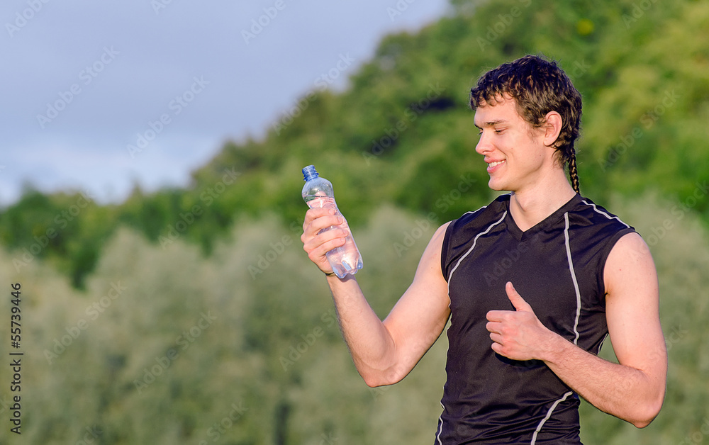 Sportsman with bottle of water gesturing OK Sportsman with bottle of water gesturing OK