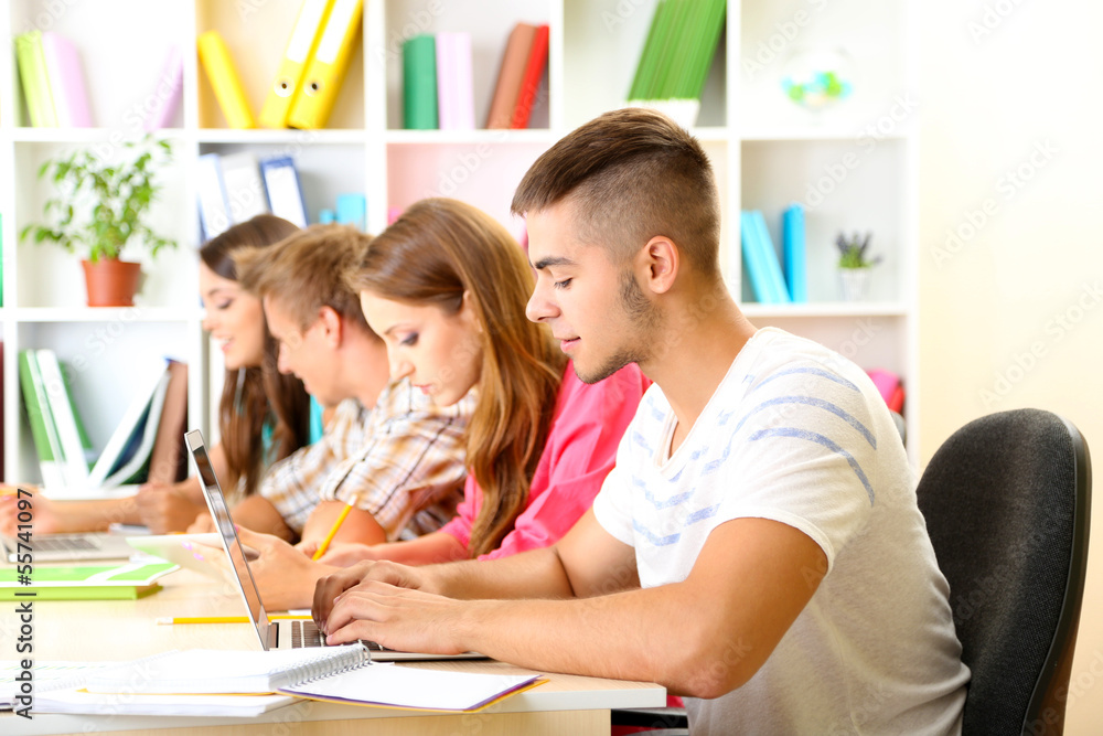 Group of young students sitting at the library Group of young students sitting at the library