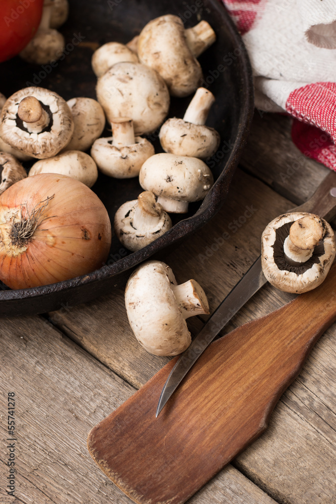 Fototapeta premium Mushrooms and fresh vegetables on the rusty pan