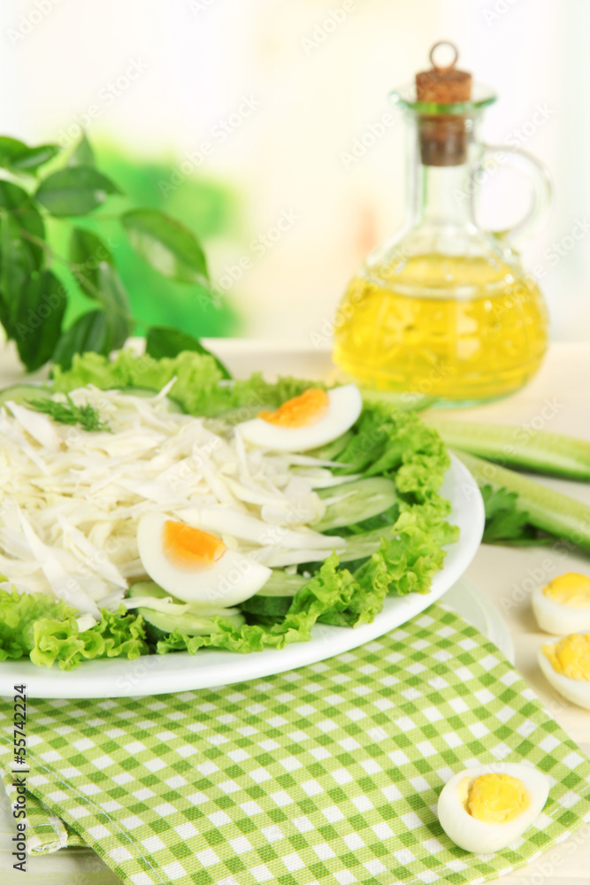 Delicious salad with eggs, cabbage and cucumbers on wooden