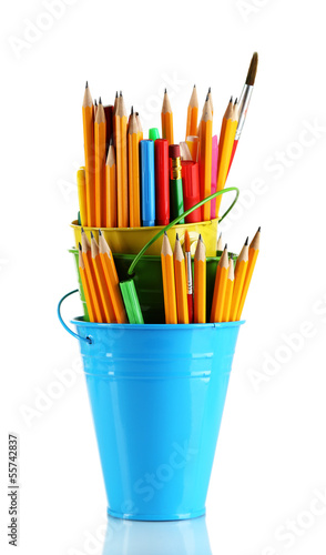 Colorful pencils and other art supplies in pails isolated