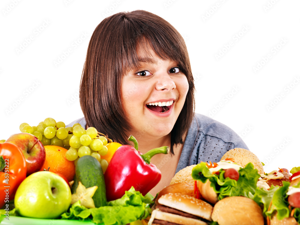 Woman choosing between fruit and hamburger. Woman choosing between fruit and hamburger.