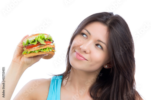 woman with tasty fast food unhealthy burger in hand to eat