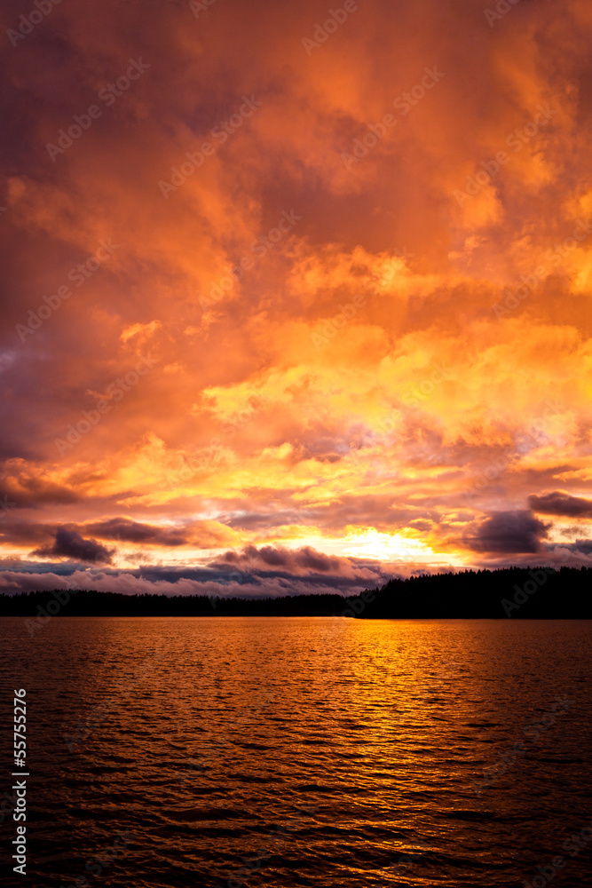 Dramatic fire red sunset over a lake