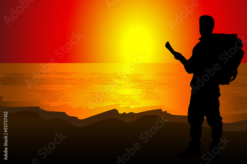 Silhouette of a man of backpacker tourists on an observat