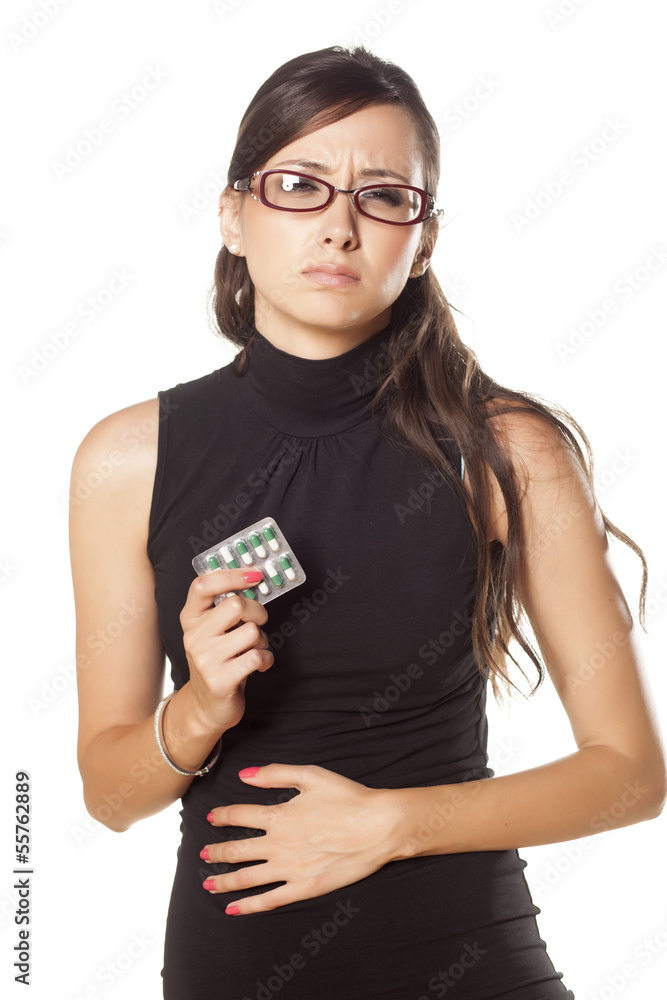 woman has pain in his stomach and holding pills in her hand woman has pain in his stomach and holding pills in her hand