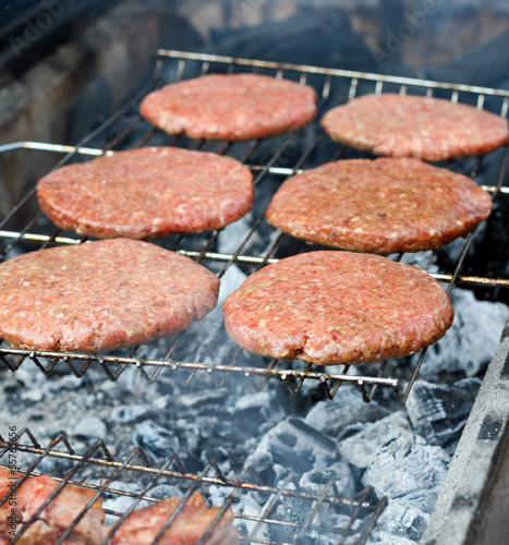 Raw meat for burgers on grill