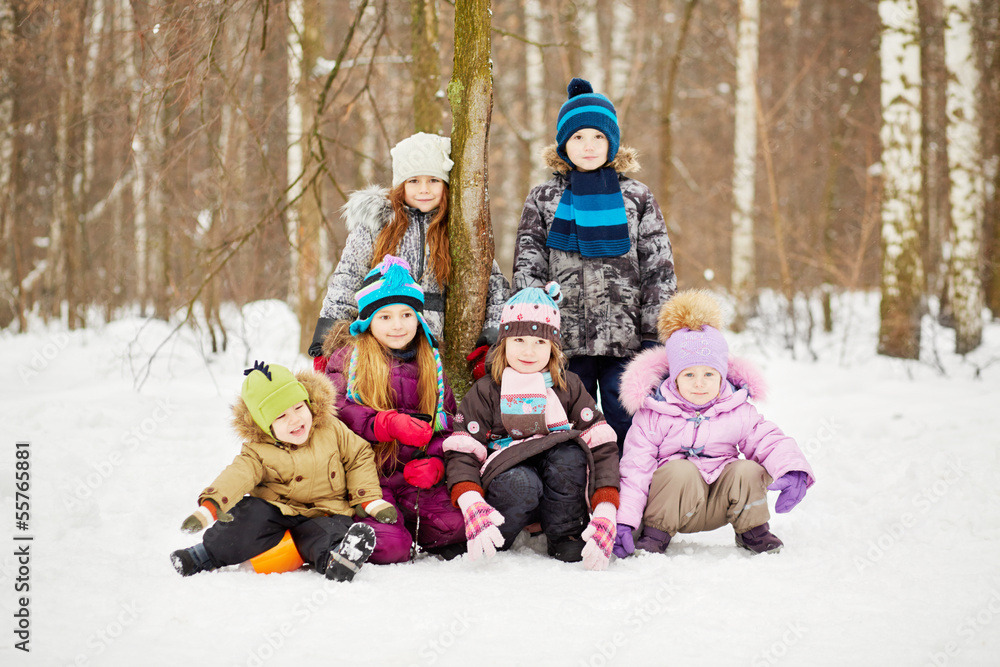 Group portrait of six children in winter park